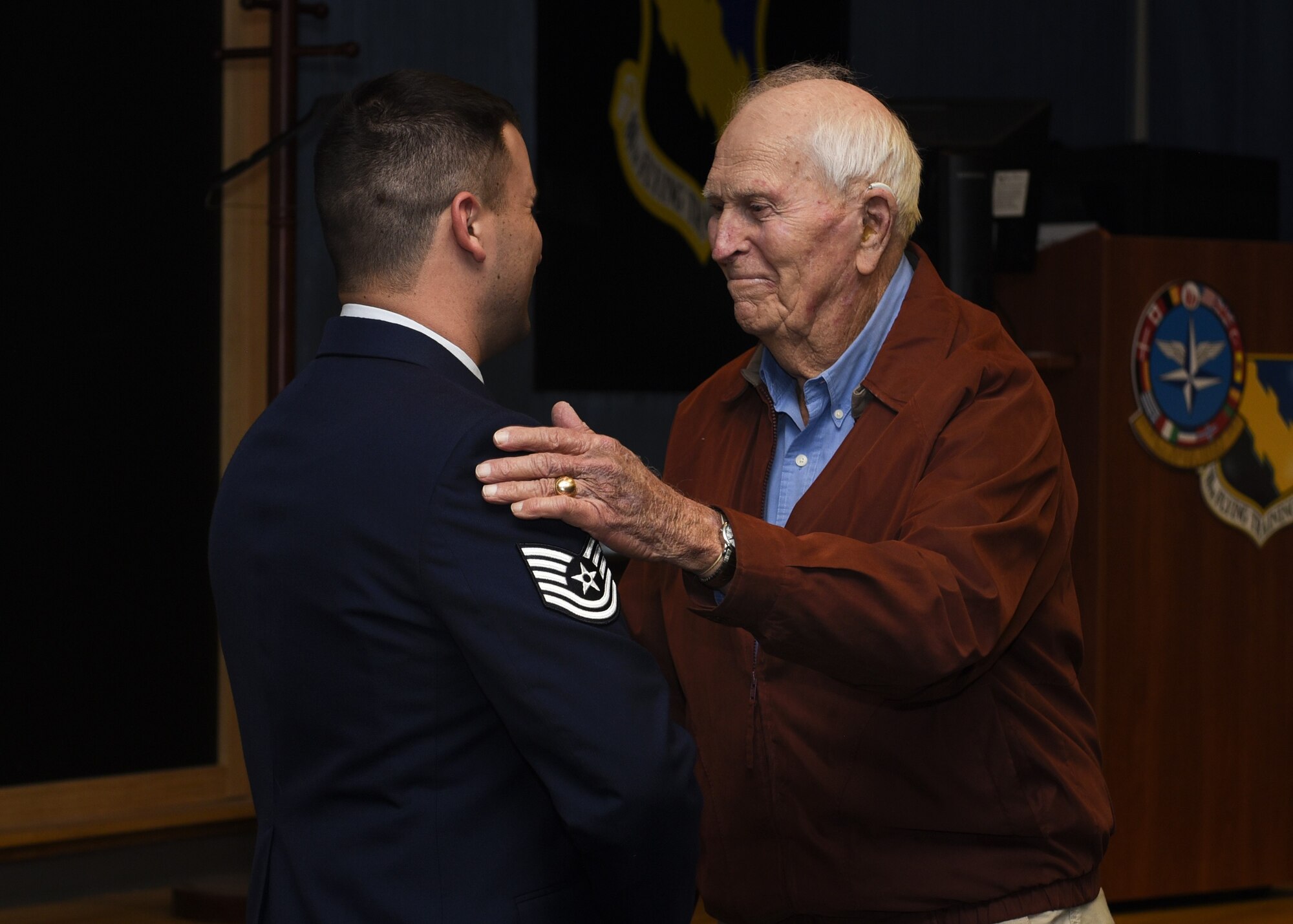Tech. Sgt. Joe Jones and his grandfather retired Army Capt. Joe Jones, shake hands at Sheppard Air Force Base, Texas, Feb. 28, 2020. Jones invited his grandfather to see him promote in person for the first time. In a monologue, Jones stated he did not think he would make it this far in his career, considering his decisions before joining the Air Force. His grandfather jokingly said he also did not think Jones would make it, but then said he is proud of his grandson for being in the Air Force.