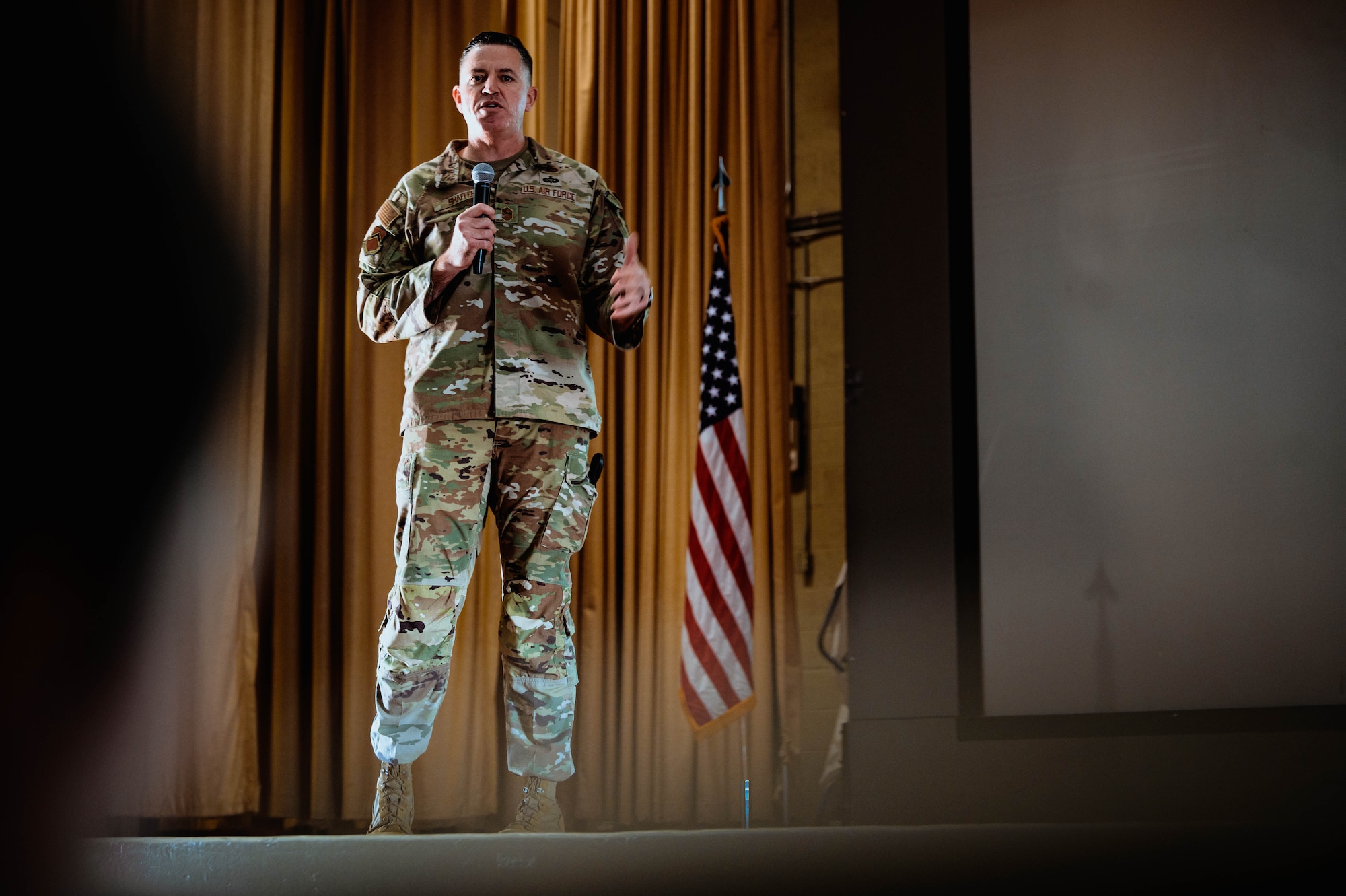 U.S. Air Force Chief Master Sgt. Jason Shaffer, 56th Fighter Wing command chief, addresses Luke Air Force Base personnel during a base all-call.