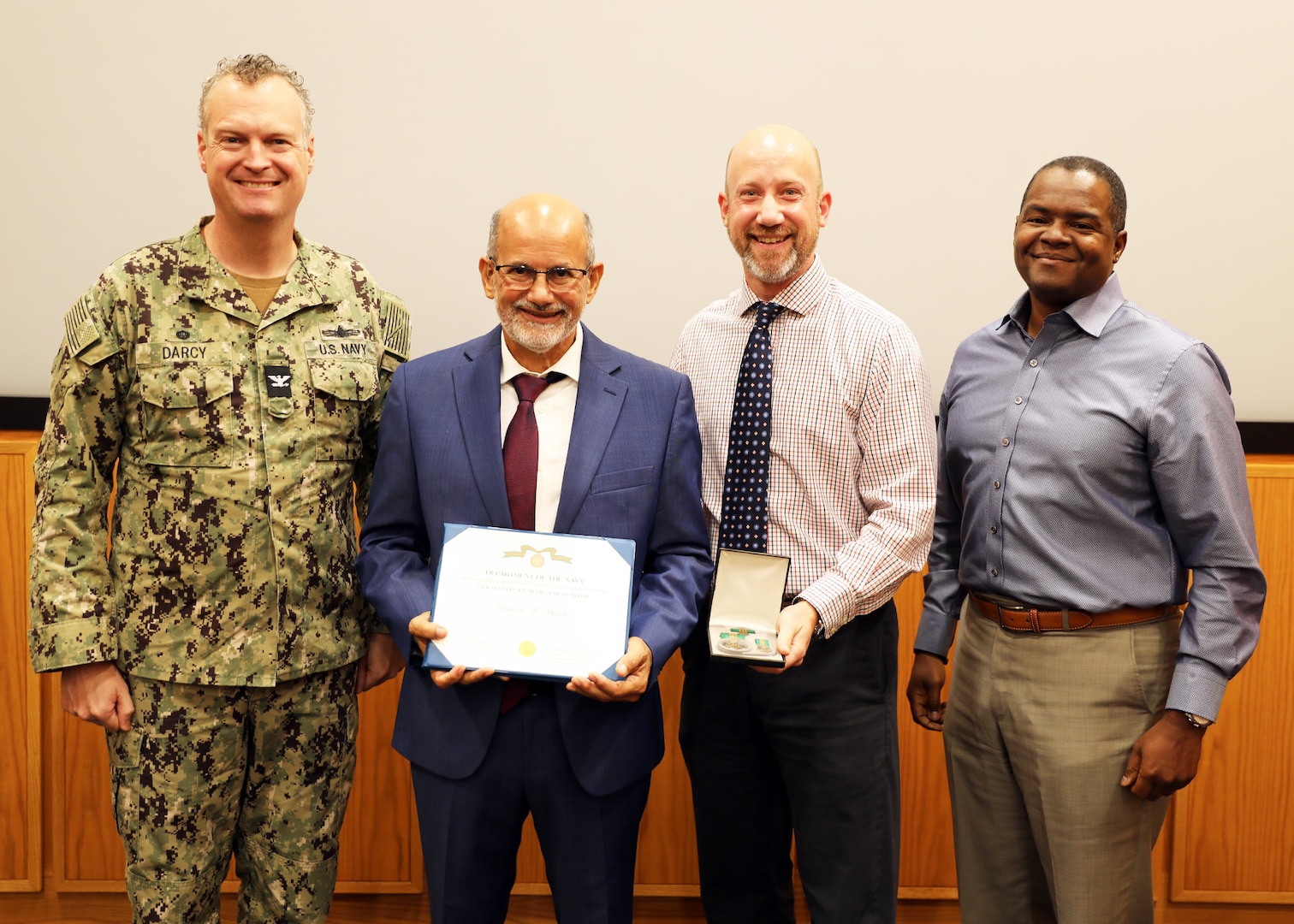 Naval Surface Warfare Center, Philadelphia Division (NSWCPD) Commanding Officer Capt. Joseph Darcy (left), Machinery Research, Logistics & Ship Integrity Department Chief Engineer (CHENG) Jeff Gosch (center right), and Technical Director (TD) Nigel C. Thijs, SES (right), present the Department of Navy (DoN) Civilian Service Achievement Medal to retired NSWCPD Branch Head Ramon “Tony” Morales (center left) who served as the keynote speaker during NSWCPD’s Hispanic Heritage Month Observance on Oct. 4, 2023. (U.S. Navy photo by Phillip Scaringi/Released)