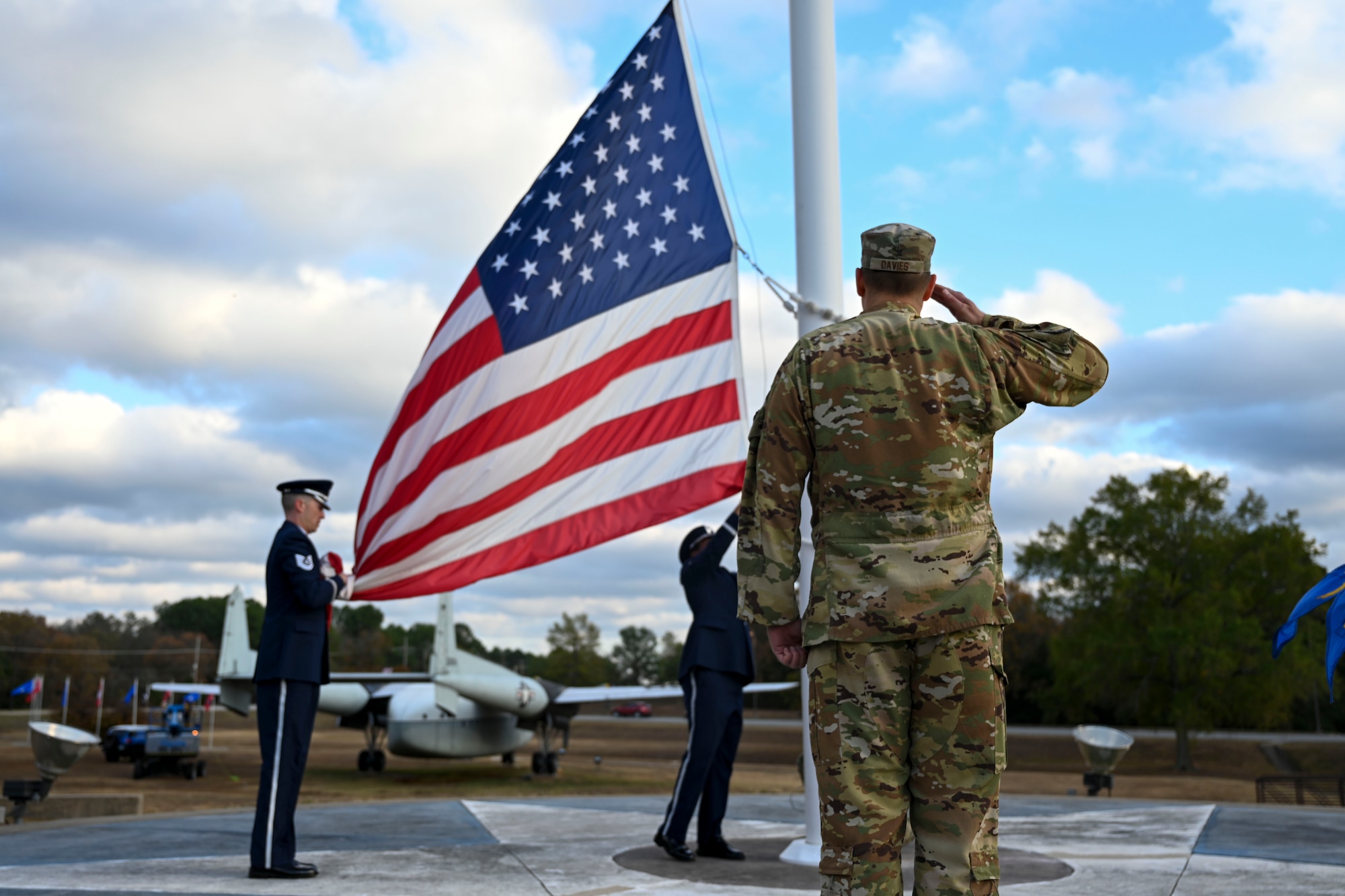 Col. Denny Davies, 19th AW and installation commander, salutes the U.S. flag