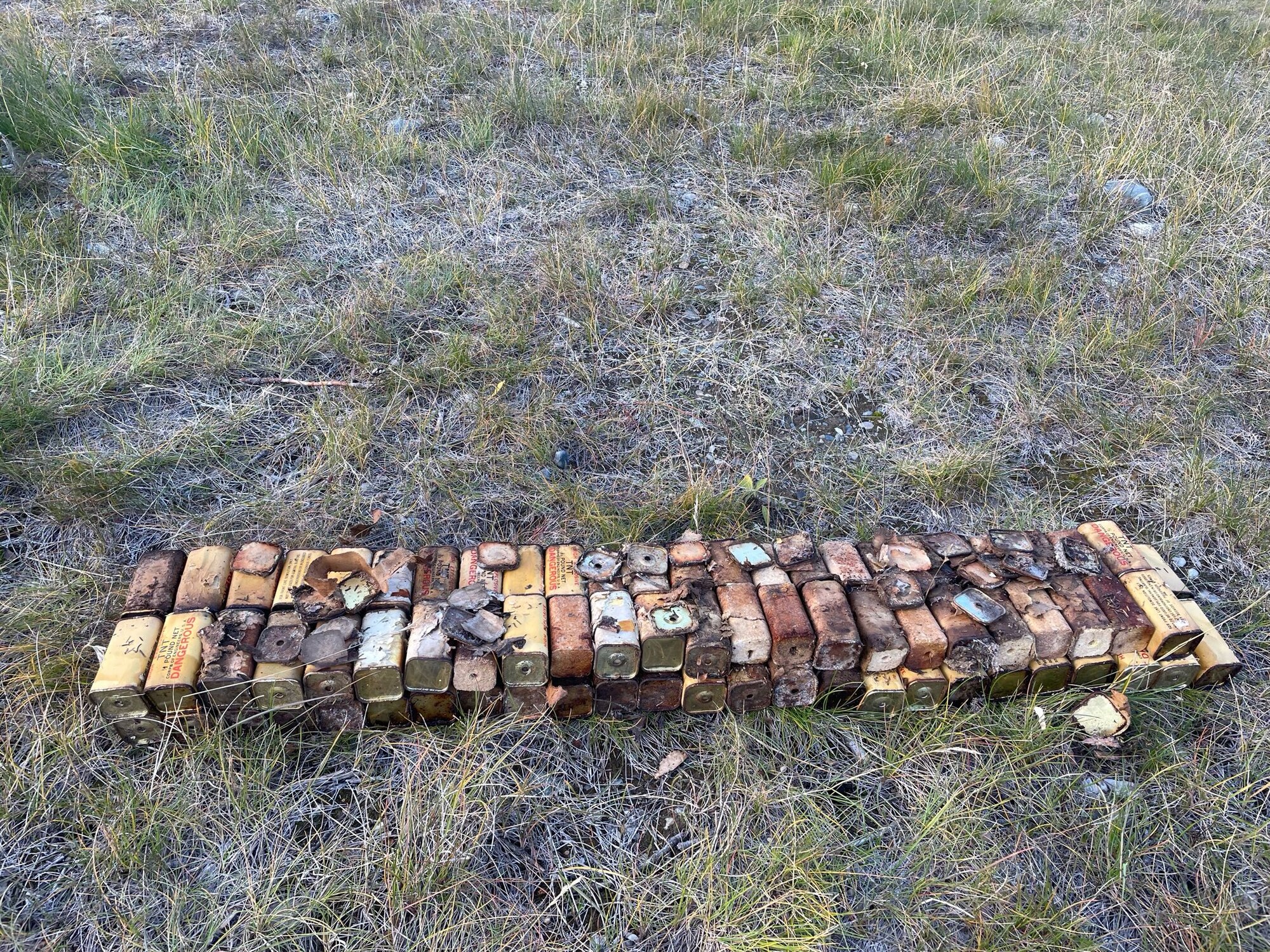 U.S. Air Force Airmen from the 354th Civil Engineering Sqaudron Explosive Ordnance Disposal, line up 98 blocks of TNT before a controlled detonation, near Tok, Alaska, Sep 28, 2023.