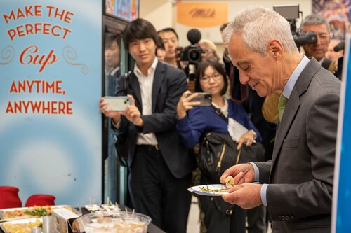 U.S. Ambassador to Japan Rahm Emanuel samples scallops at the commissary on Yokota Air Base, Japan.