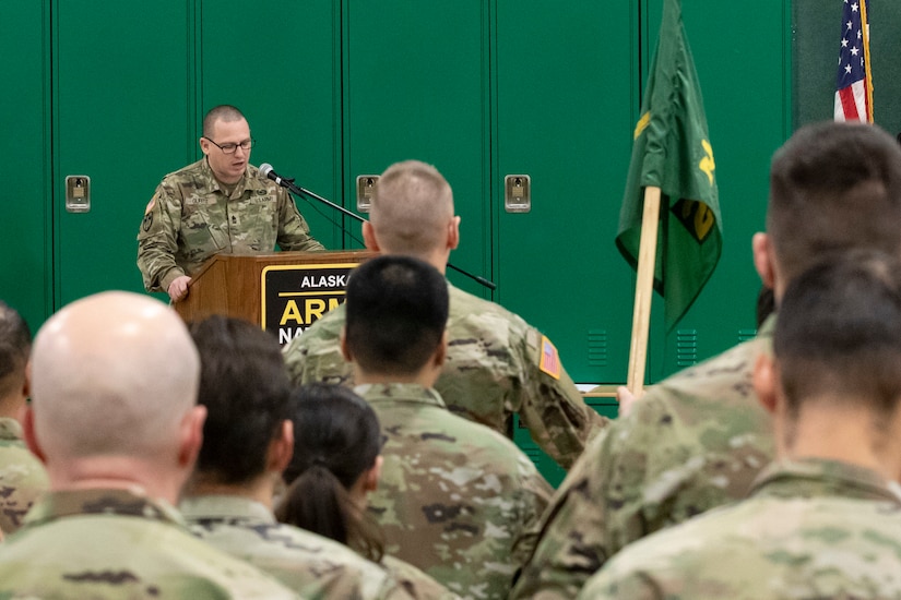 Alaska Army National Guard 1st Sgt. Benjamin Guritz, the guest speaker, speaks to his audience about the history of the 297th Military Police Company as part of a deactivation ceremony for the company at the Alcantra Armory in Wasilla, Alaska, Nov. 2, 2023.
