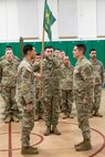 Alaska Army National Guard 1st Lt. Kenneth McCoy, left, incoming commander, and Sfc. Gerry Lopez, noncommissioned officer in charge, both assigned to the 297th Military Police Detachment, present the colors during an activation ceremony for the detachment at the Alcantra Armory in Wasilla, Alaska, Nov. 2, 2023.