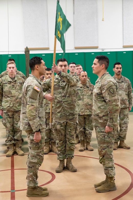 Alaska Army National Guard 1st Lt. Kenneth McCoy, left, incoming commander, and Sfc. Gerry Lopez, noncommissioned officer in charge, both assigned to the 297th Military Police Detachment, present the colors during an activation ceremony for the detachment at the Alcantra Armory in Wasilla, Alaska, Nov. 2, 2023.