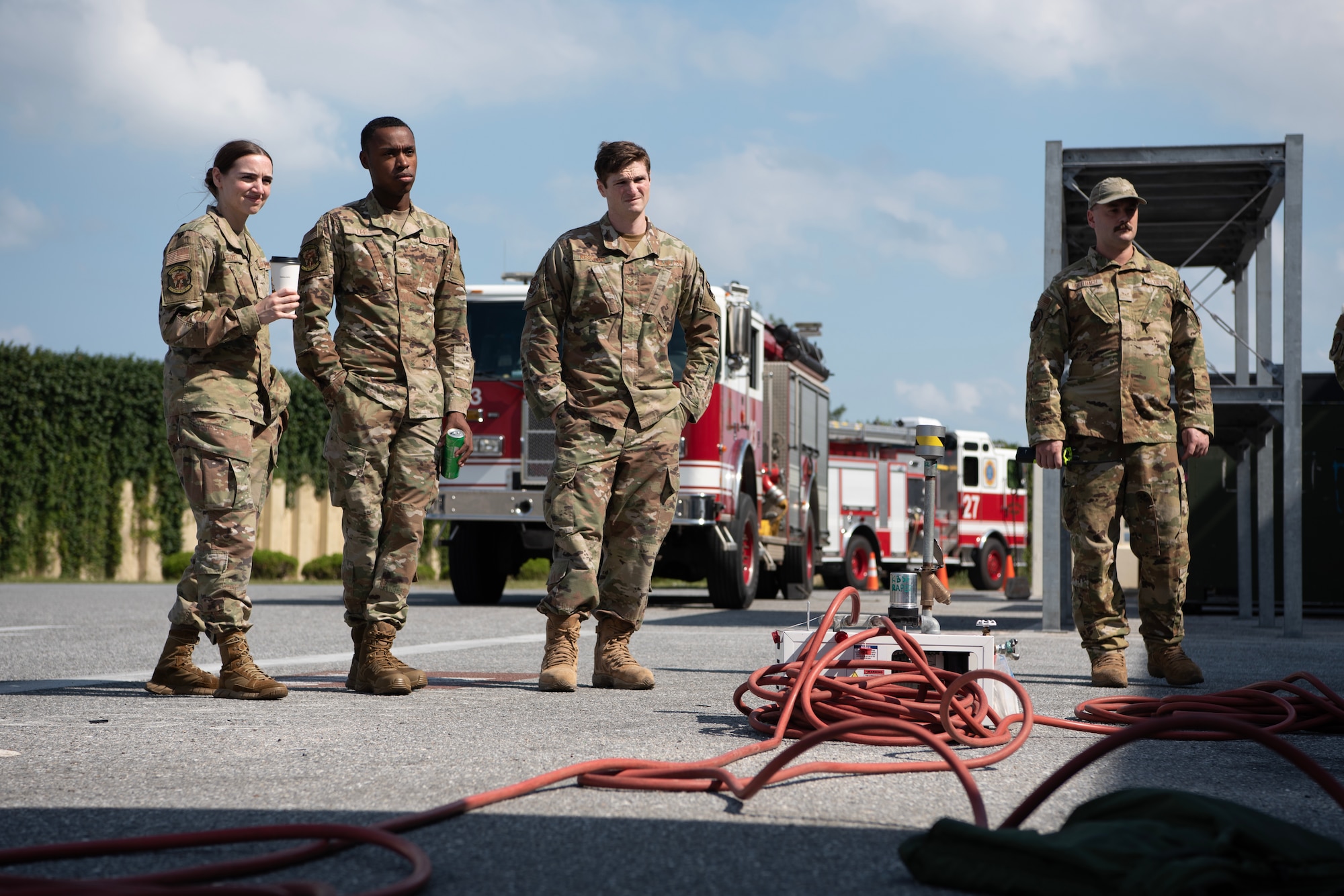 Airmen observe extraction demonstration in front of firetrucks