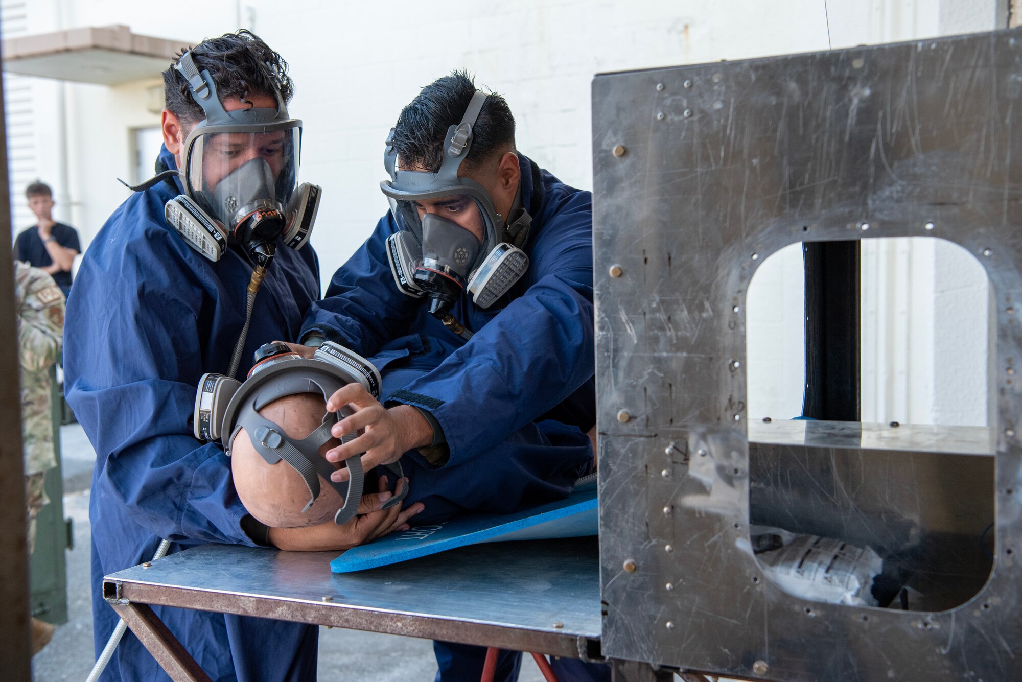 two craftsmen demonstrate extraction procedures on mannequin