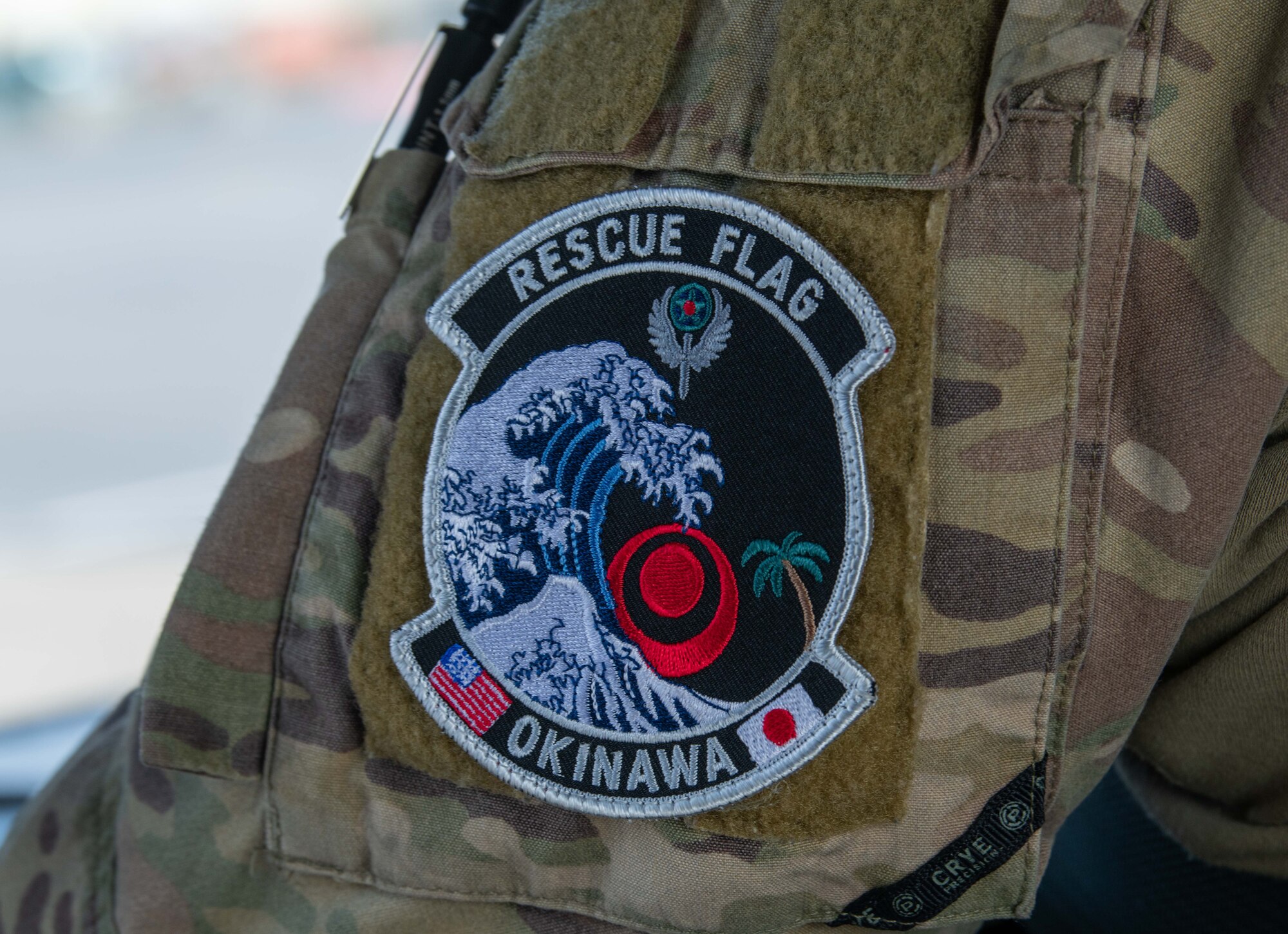 A Japan Air Self-Defense Force service member wears a patch commemorating Rescue Flag Okinawa 2023 at Kadena Air Base, Japan, Oct. 24, 2023.