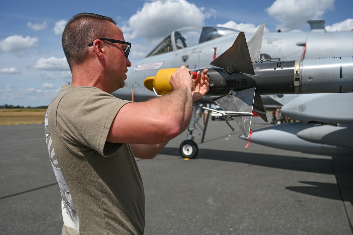 U.S. Air Force Tech. Sgt. Matthew Smyth, a weapons specialist assigned to the 175th Aircraft Maintenance Squadron, 175th Wing, Maryland National Guard, puts a ground safety cover on the AIM-9 missile on an A-10C Thunderbolt II aircraft after the unit’s final training sortie during exercise Air Defender 2023 (AD23), June 22, 2023, at Jagel Air Base, Germany.