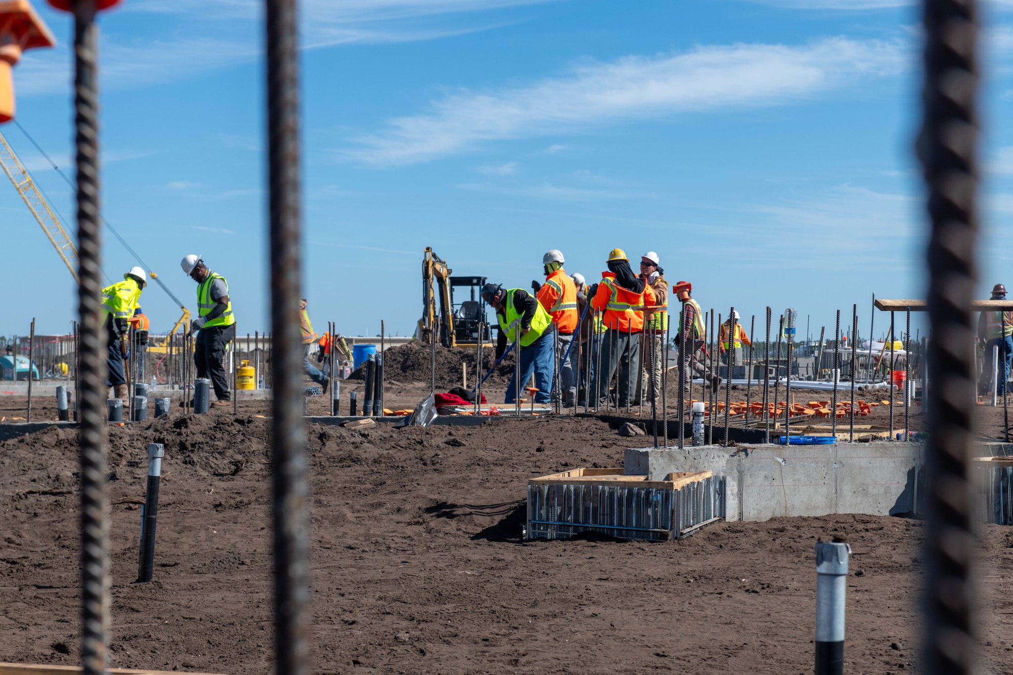 A group of construction workers can be seen working on a construction site.