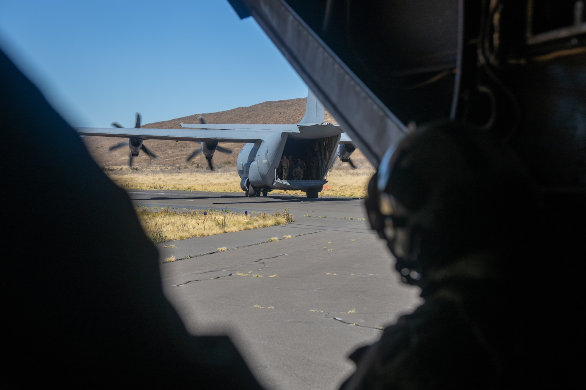 Marines look at a C-130.