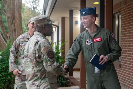 Chief Williams, center, shaking hands with Col Lange.