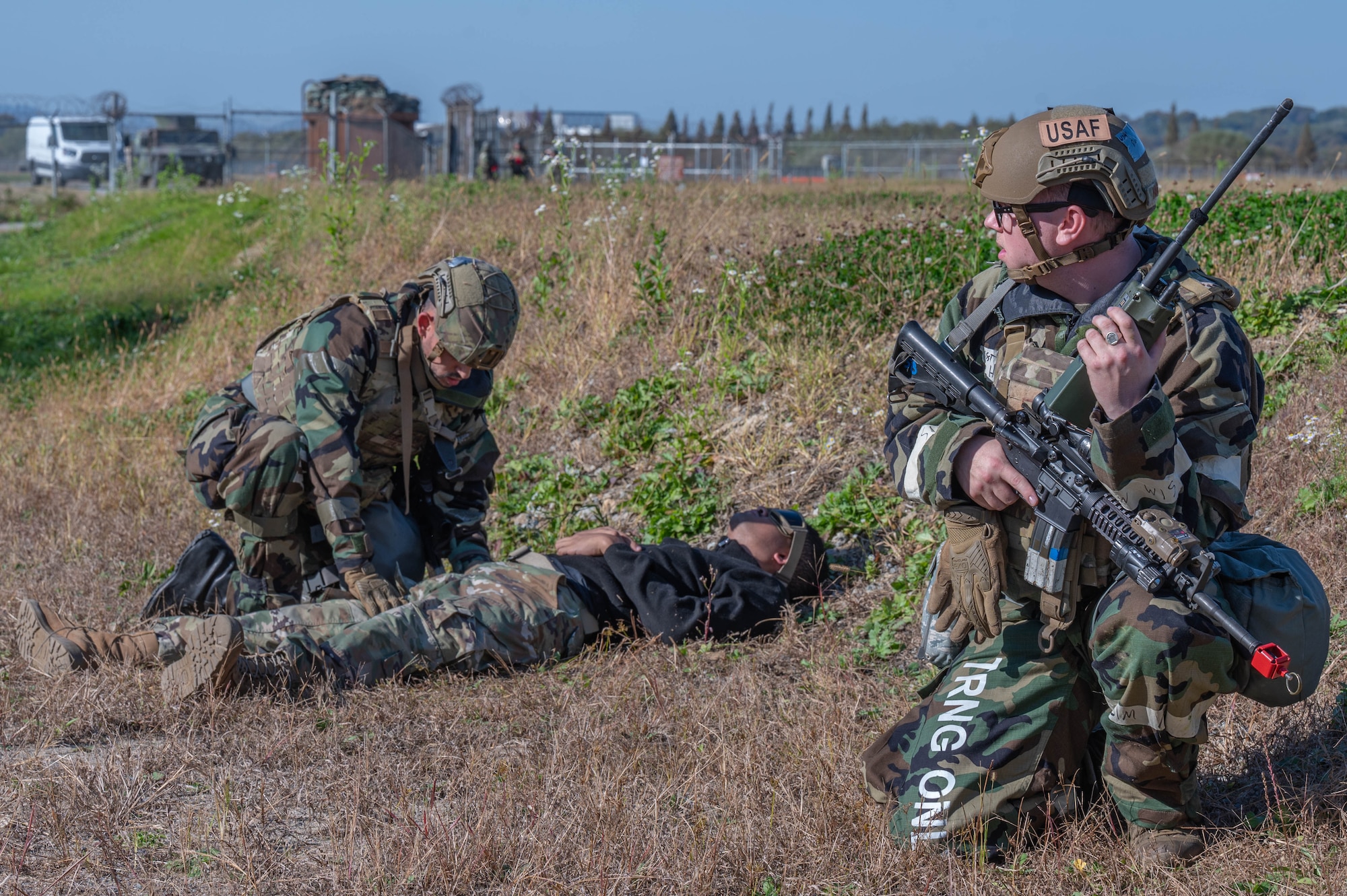 U.S. Air Force Defenders with the 51st Security Forces Squadron, assess a simulated opposing force casualty during a training scenario during Vigilant Defense 24 at Osan Air Base, Republic of Korea, Nov. 2, 2023. Practice scenarios are evaluated by members of the wing inspection team to ensure that Airmen maintain a standard that ensures the mission will be executed efficiently. VD24 is a routine training event that tests the military capabilities across the peninsula, allowing combined and joint training at both the operational and tactical levels. (U.S. Air Force photo by Airman 1st Class Chase Verzaal)