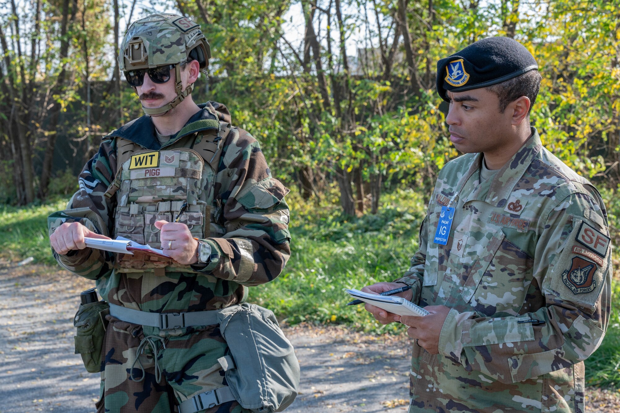 U.S. Air Force Tech. Sgt. Michael Pigg, 51st Security Forces Squadron military working dog trainer supervisor, left, and Master Sgt. James Baldwin, Pacific Air Forces wing inspection team member, evaluate a simulated tactical combat casualty care scenario for 51st SFS MWD handlers, to practice on a K-9 training asset during Vigilant Defense 24 at Osan Air Base, Republic of Korea, Nov. 2, 2023. Evaluating simulated emergencies, like responding to a critically wounded MWD, ensures Airmen maintain the level of readiness that allows Osan to execute the mission with consistency and precision in the event of a real-world threat. VD24 is a routine training event that tests the military capabilities across the peninsula, allowing combined and joint training at both the operational and tactical levels. (U.S. Air Force photo by Airman 1st Class Chase Verzaal)