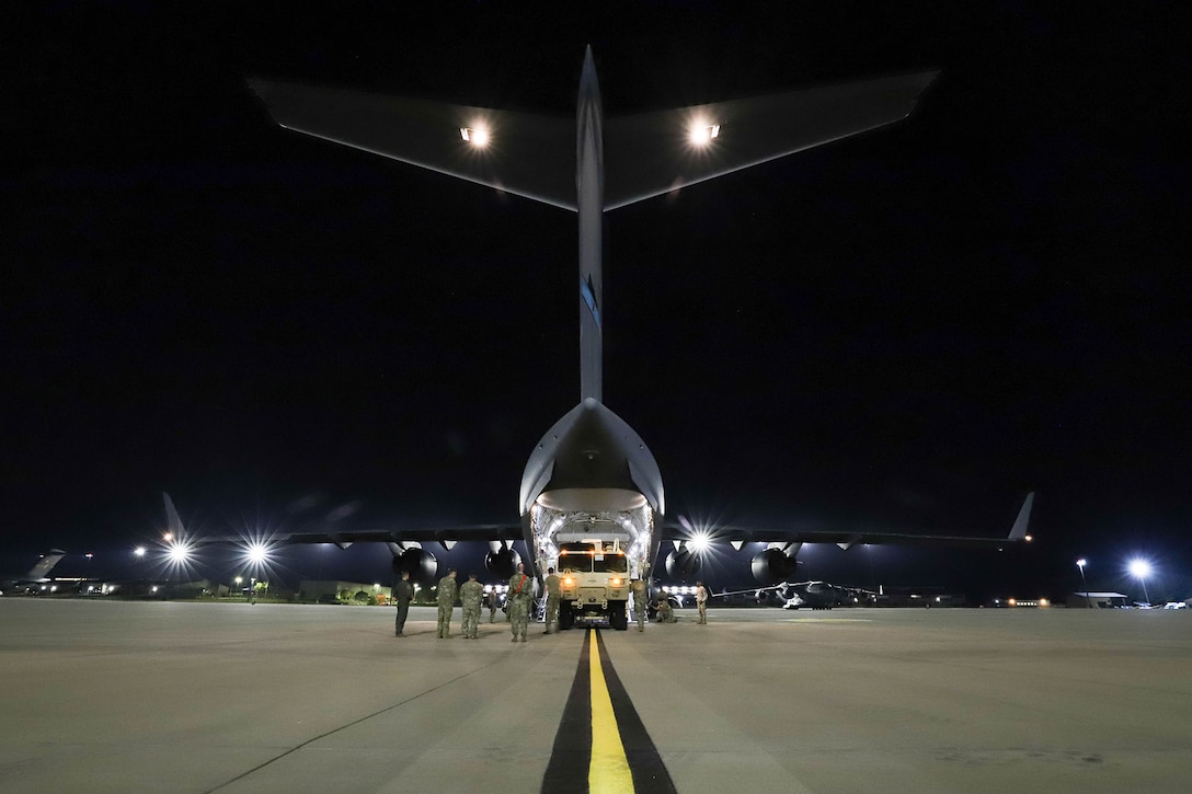 Soldiers load a Patriot Launching Station onto an Air Force C-17.