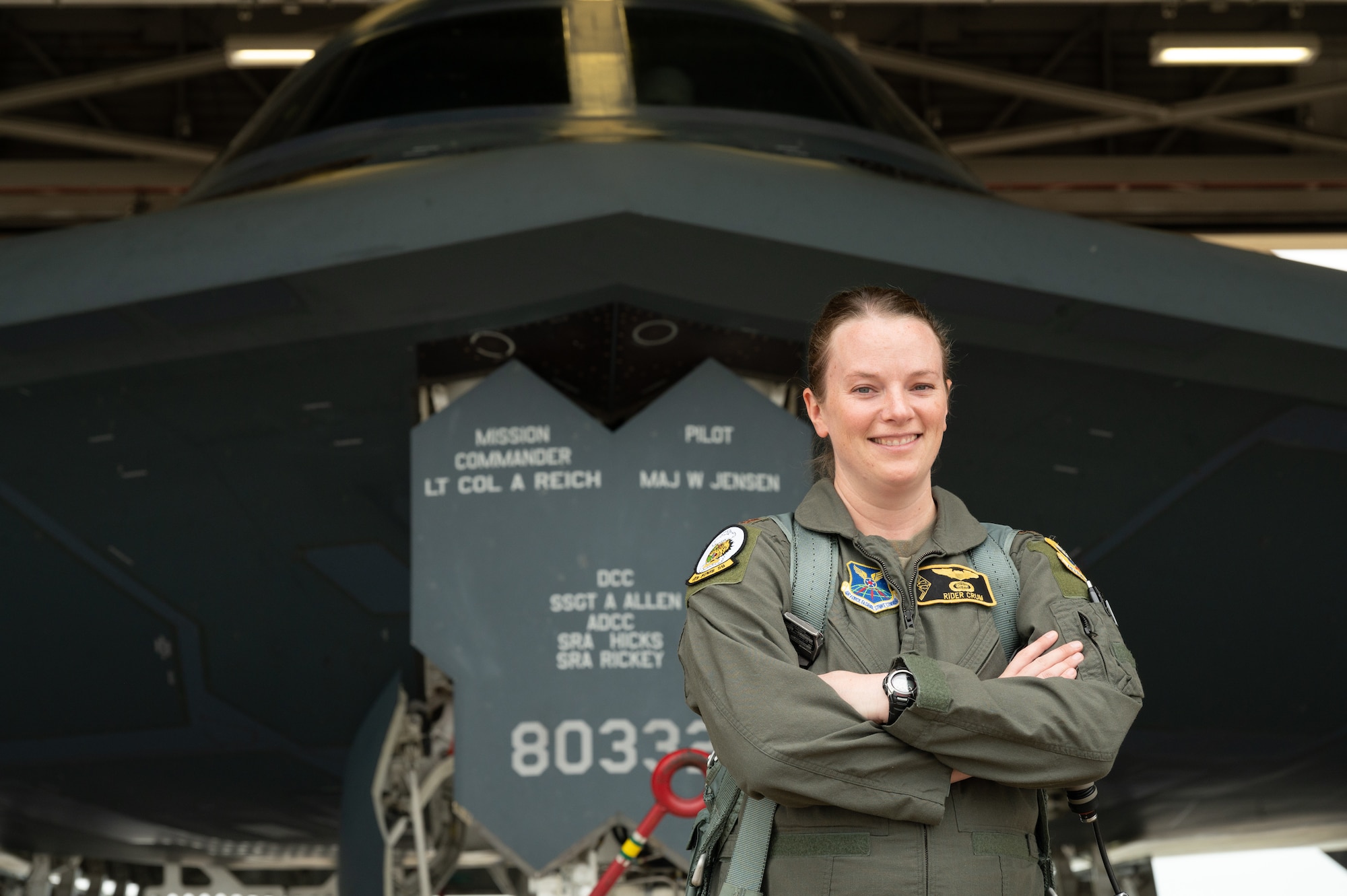 U.S. Air Force Capt. Jennifer Crum, 393rd Bomb Squadron assistant director of operations, Poses in front of a B-2 Spirit Bomber for a photo at Whiteman Air Force Base, Mo., Sept. 10, 2023. Crum is the first pregnant B-2 pilot in the 30 years the airframe has been active. (U.S. Air Force photo by Airman 1st Class Joseph Garcia)