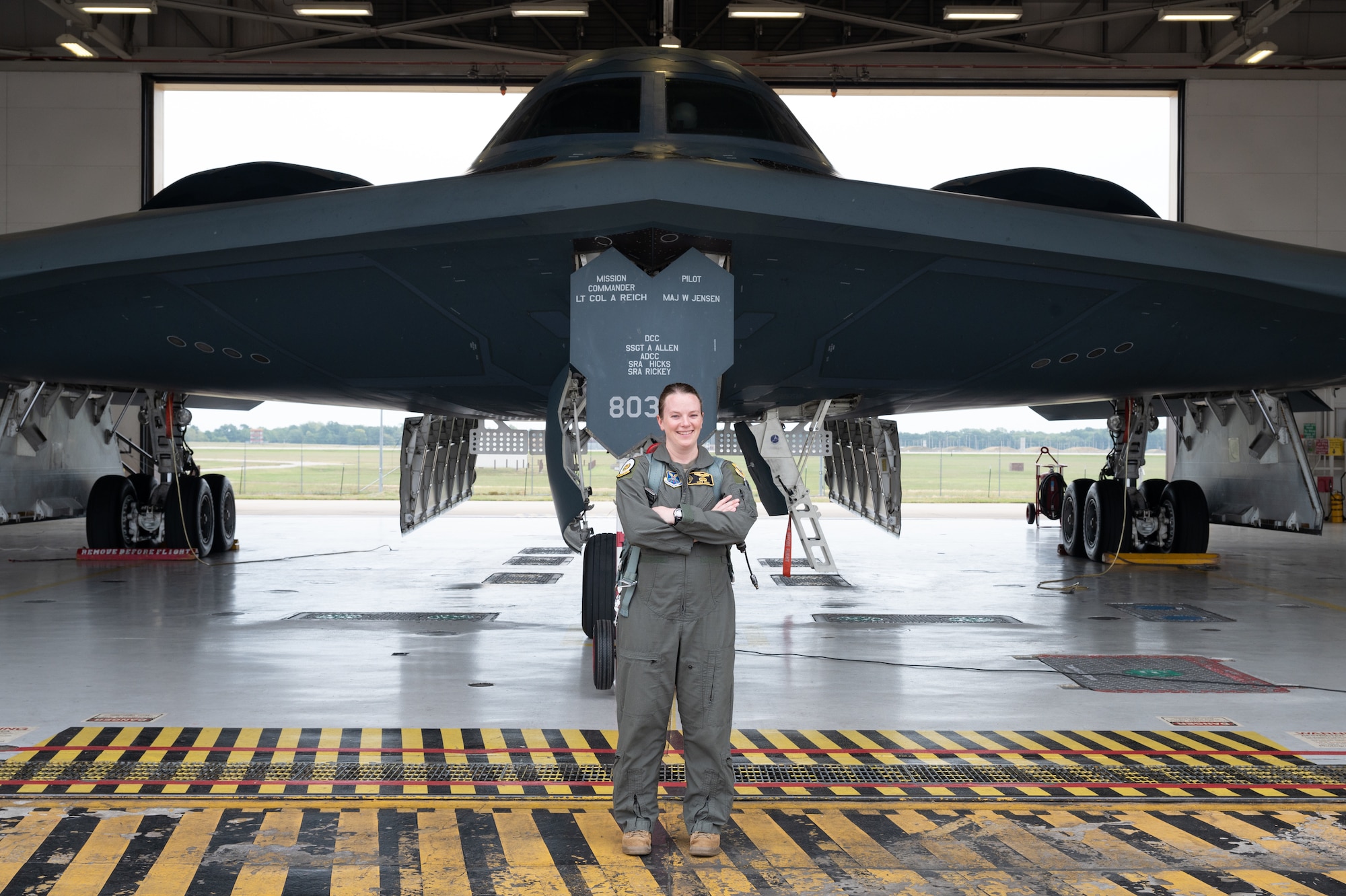 U.S. Air Force Capt. Jennifer Crum, 393rd Bomb Squadron assistant director of operations, Poses in front of a B-2 Spirit Bomber for a photo at Whiteman Air Force Base, Mo., Sept. 10, 2023. Crum is the first pregnant B-2 pilot in the 30 years the airframe has been active. (U.S. Air Force photo by Airman 1st Class Joseph Garcia)