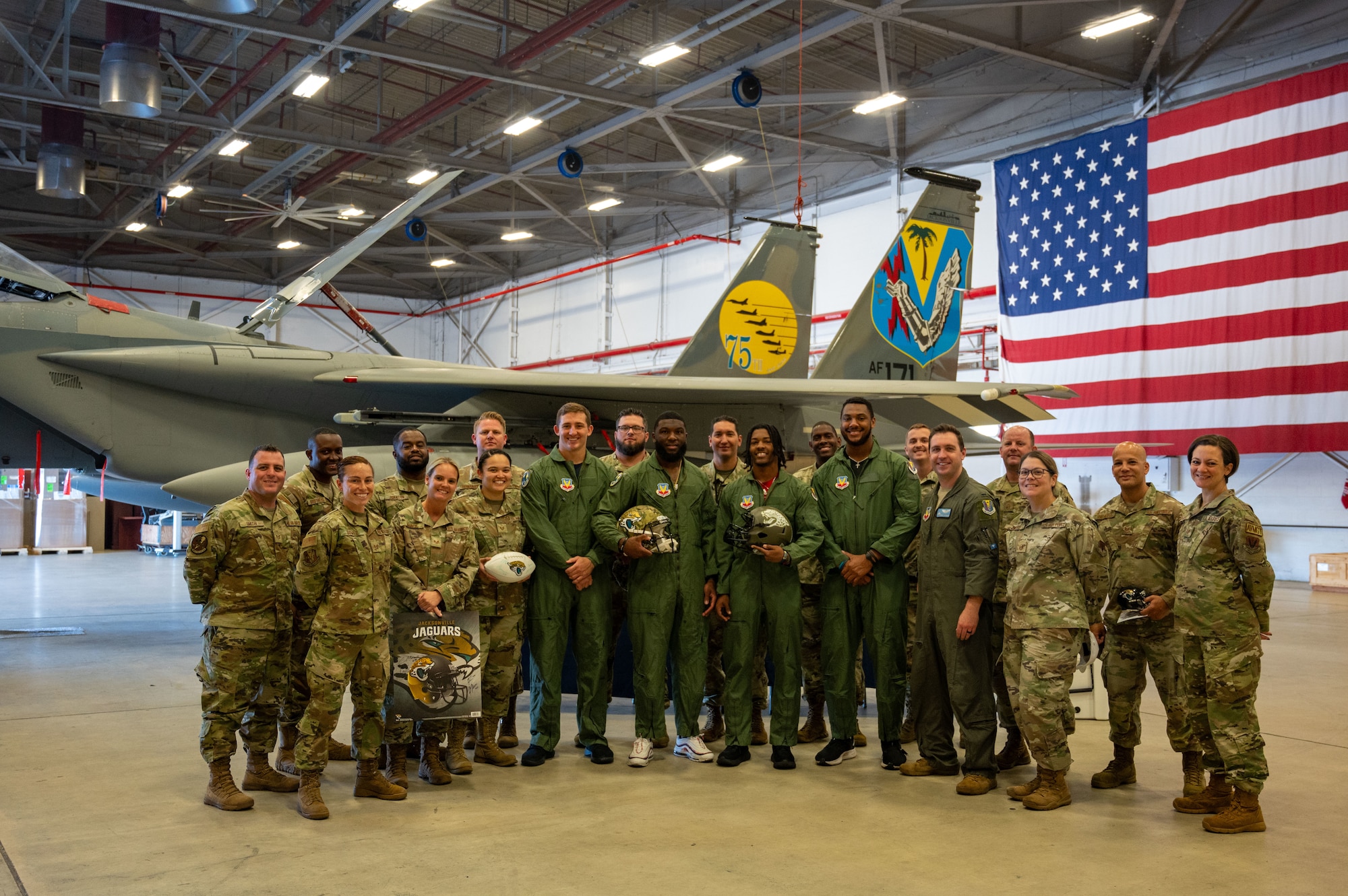 Officials at the 125th Fighter Wing welcomed players from the Jacksonville Jaguars for a base tour Nov. 7, 2023 at Jacksonville Air National Guard Base, Florida. The players included linebackers Chad Muma and Dequan Jackson, defensive lineman De’Shaan Dixon, and defensive back Christian Braswell. During the tour, the players learned of the war fighting capabilities of the F-15C Eagle, donned aircrew flight equipment, viewed a static F-15 display, and engaged with Airmen from around the wing. The tour supported efforts to establish positive relationships, enhance public understanding, and promote mutual support between the 125th Fighter Wing and the local communities in which it operates. (U.S. Air National Guard photo by Tech Sgt. Chelsea Smith)
