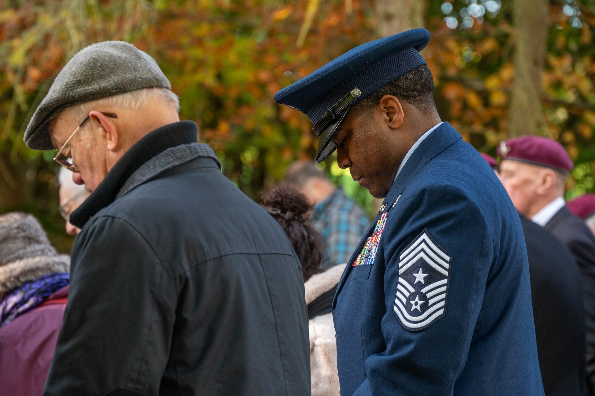 Members bow their heads in prayer during a Remembrance Day ceremony.