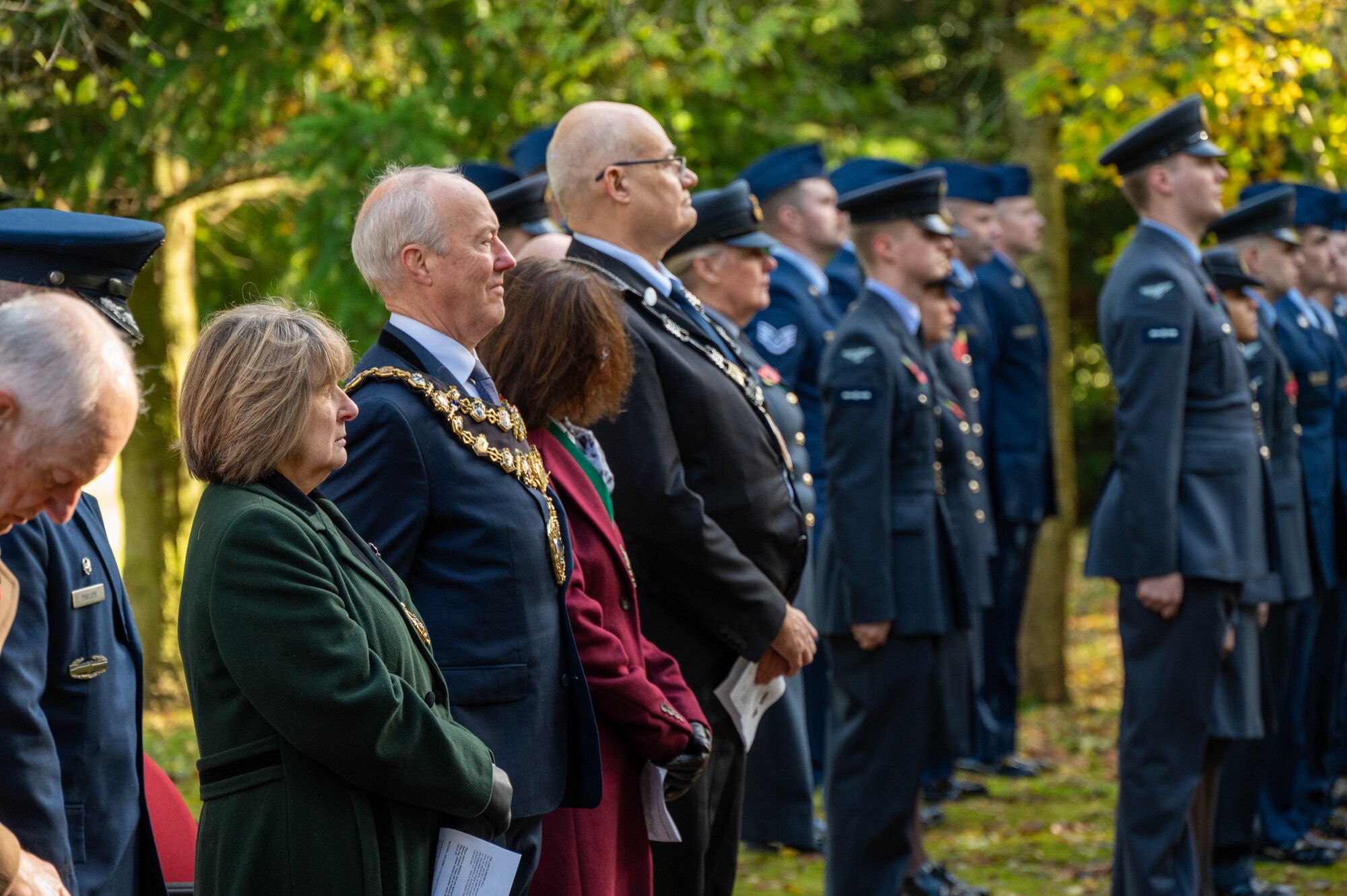Guests stand in unity during a Remembrance Day ceremony.