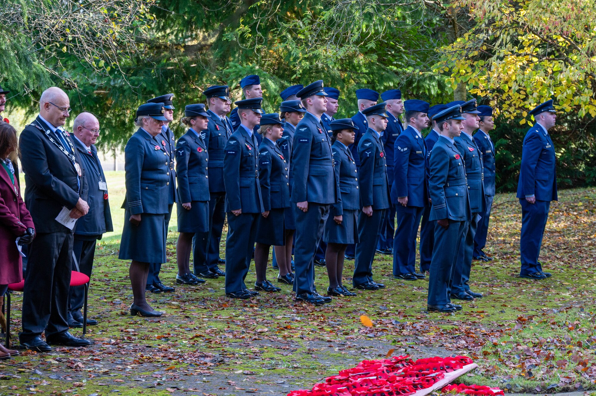 U.S. and U.K. Airmen stand in formation during a Remembrance Day ceremony.