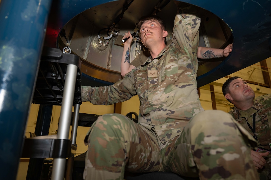 Senior Airman Jonathan Schermerhorn, Maintainer in the 90th Munitions Squadron, works on a trainer warhead during the 2023 Global Strike Challenge, August 17, 2023, in the Weapon Storage Area on F.E. Warren Air Force Base, Wyoming. The indoor portion of the challenge required a five-member team to assemble a trainer warhead as fast and accurately as possible. (U.S. Air Force photo by Senior Airman Sarah Post)
