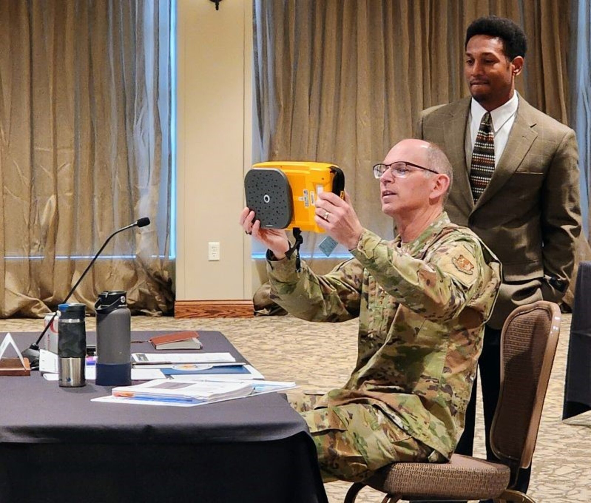 Gen. Duke Z. Richardson, commander, Air Force Materiel Command, holds an acoustic scanner while Wayne Horton, Ultrasound lead, Condition Base Maintenance Group, Arnold Engineering Development Complex, looks on, Oct. 19, 2023, at Wright-Patterson Air Force Base, Ohio. The acoustic scanner was a semi-finalist in the AFMC Spark Tank Integrated Capabilities challenge. (Courtesy photo)