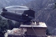 A CH-47 Chinook helicopter piloted by Chief Warrant Officer 3 Larry Murphy and Chief Warrant Officer 3 Paul Barnes of the Pennsylvania National Guard’s Company G, 104th Aviation Regiment lands on the roof of a house in northeastern Afghanistan to evacuate detainees on Nov. 10, 2003. (U.S. Army photo by Sgt. Greg Heath)