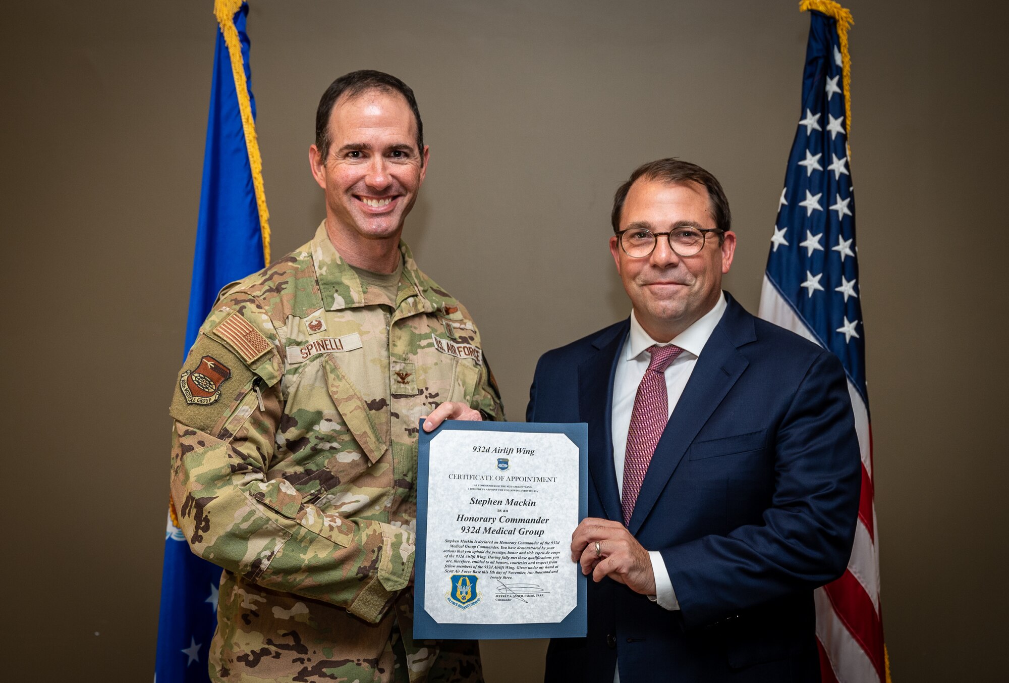 Steve Mackin, Mercy President and CEO, and the newly instated 932nd Medical Group Honorary Commander, is presented his certificate of appointment into the 932nd Airlift Wing Honorary Commanders program by Col. Christopher Spinelli, MDG commander, Nov 5th, 2023, Scott Air Force Base, Illinois. The Honorary Commanders will serve as a liaison between service members and the public to increase communication and collaboration between the military and the local community, giving Citizen Airmen and surrounding townships a greater appreciation of one another. (U.S. Air Force photo by Christopher Parr)