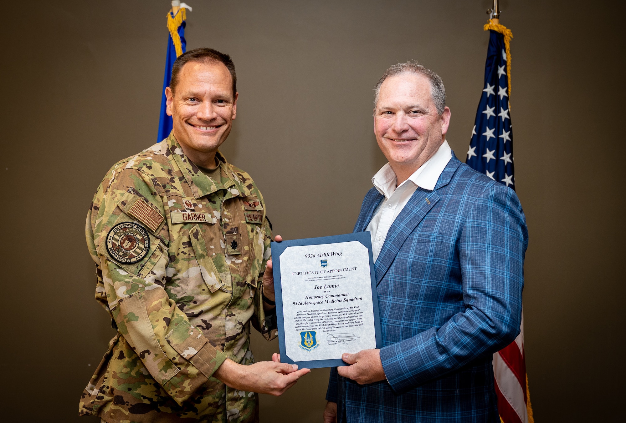 Joe Lamie, Managing Editor, KTVI/KPLR TV News, and the newly instated 932nd Airlift Wing Aerospace Medicine Squadron Honorary Commander, is presented his certificate of appointment into the 932nd Airlift Wing Honorary Commanders program by Lt. Col Robert Garner, AMDS commander, Nov 5th, 2023, Scott Air Force Base, Illinois. The Honorary Commanders will serve as a liaison between service members and the public to increase communication and collaboration between the military and the local community, giving Citizen Airmen and surrounding townships a greater appreciation of one another. (U.S. Air Force photo by Christopher Parr)