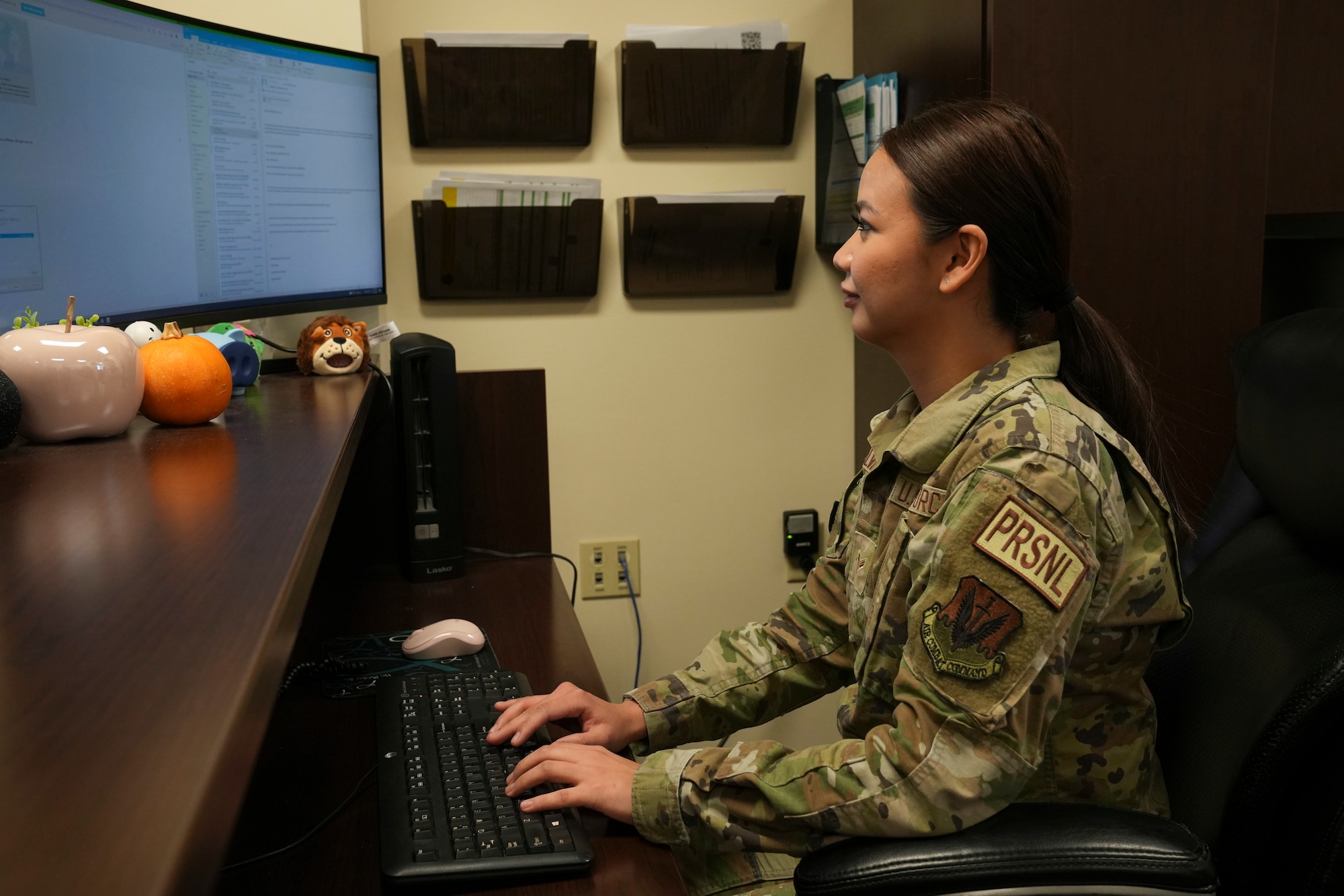 Airman 1st Class Elisa Salvador works at her computer.