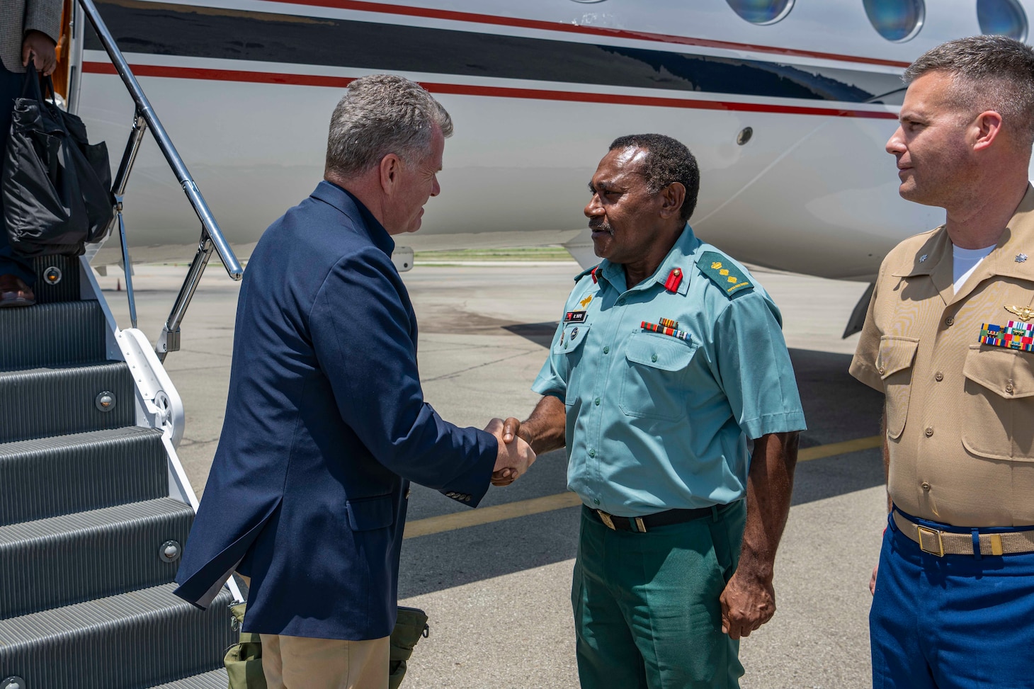 Adm. Samuel Paparo, commander, U.S. Pacific Fleet, left, greets Col. Raphael Yapu, chief of staff, Papua New Guinea Defense Force, upon arrival at Port Moresby, Papua New Guinea, Nov. 9, 2023. The visit to Papua New Guinea underscores the United States’ commitment to strengthening partnerships for an enduring resilient, free and open Indo-Pacific. (U.S. Navy photo by Mass Communication Specialist 2nd Class Jeremy R. Boan)