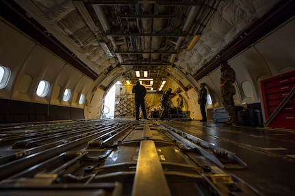 Photo of crew members loading a commercial KDC-10 Tanker aircraft