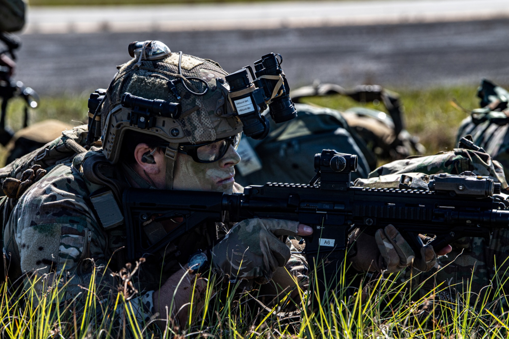 A U.S. Air Force Pararescueman assigned to the 38th Rescue Squadron scans for threats during a Full Mission Profile exercise at Moody Air Force Base, Georgia, Nov. 2, 2023. The training empowered Airmen in decision making thus enabling initiative, flexibility and responsiveness for mission success in real-world situations. (U.S. Air Force Photo by Senior Airman Courtney Sebastianelli)