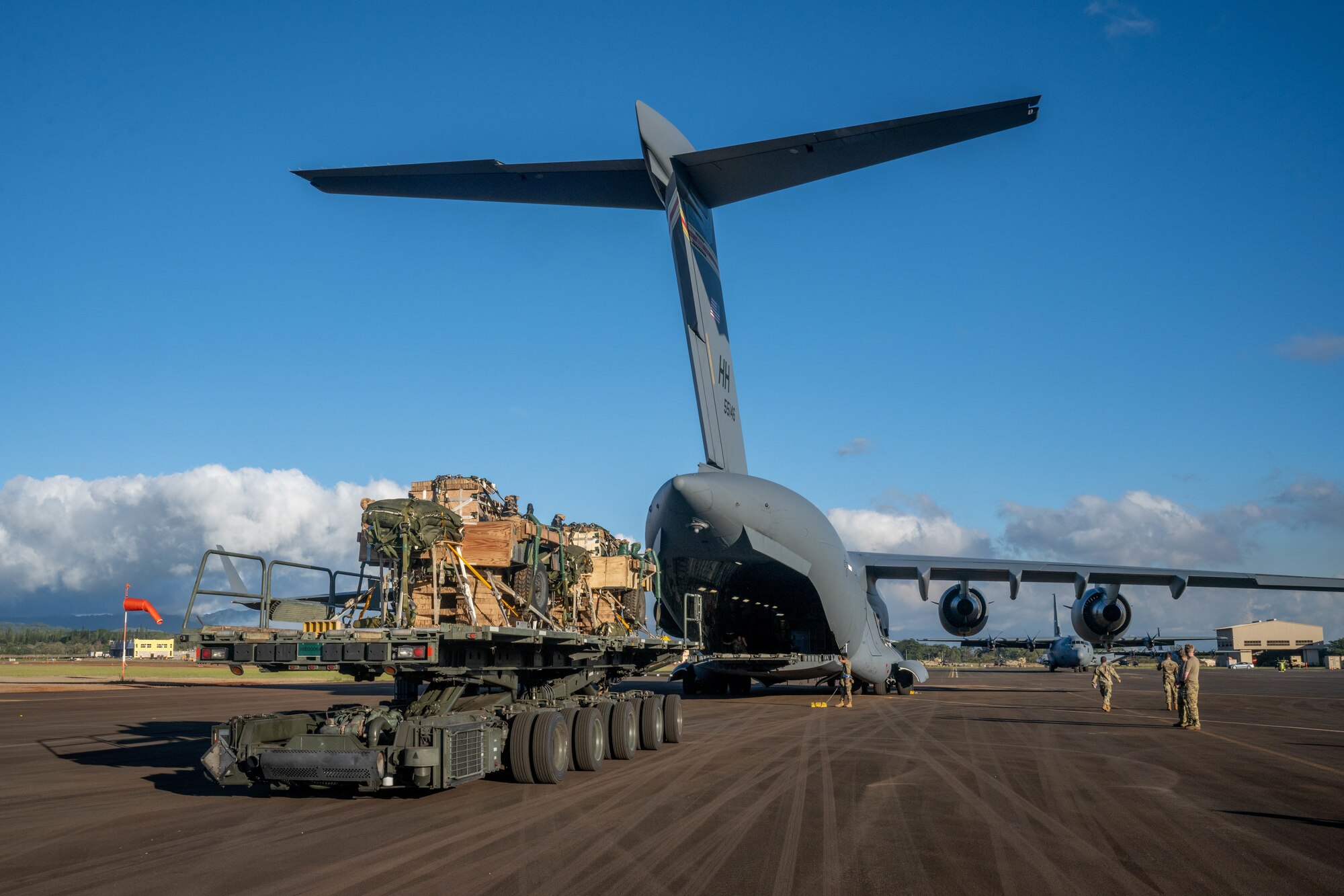Airmen assigned to the 621st Contingency Response Squadron load cargo for an airdrop mission during the Joint Pacific Multinational Readiness Center 24-01 at Wheeler Army Airfield, Hawaii, Nov. 3, 2023. Realistic training exercises with our allies and partners, like JPMRC, strengthen defense relationships, foster multinational interoperability, generate readiness and combat-credible fighting formations.  (U.S. Air Force photo by Senior Airman Makensie Cooper)