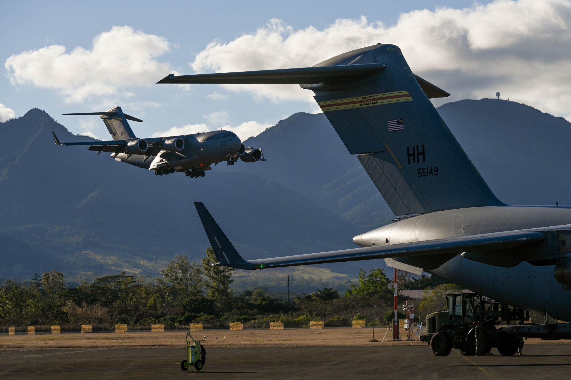 An inbound C-17 Globemaster III lands during the Joint Pacific Multinational Readiness Center 24-01 at Wheeler Army Airfield, Hawaii, Nov. 3, 2023. The Joint Pacific Multinational Readiness Center is the Army’s newest Combat Training Center and generates readiness in the environments and conditions where our forces are most likely to operate. JPMRC 24-1 includes over 5,300 training participants from across the U.S. Joint Force, New Zealand, the United Kingdom, Indonesia and Thailand. (U.S. Air Force photo by Senior Airman Makensie Cooper)