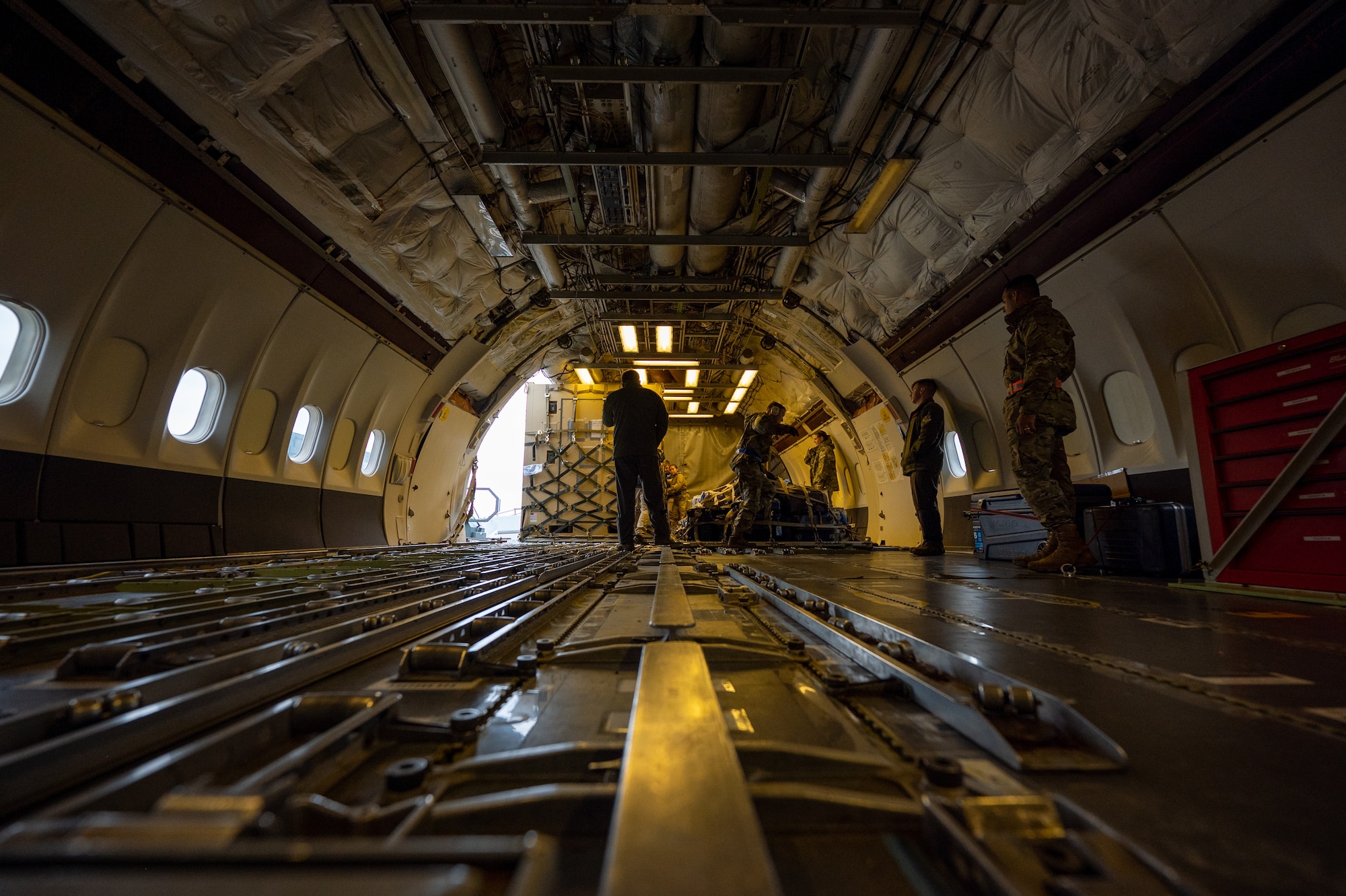 Photo of crew members loading a commercial KDC-10 Tanker aircraft
