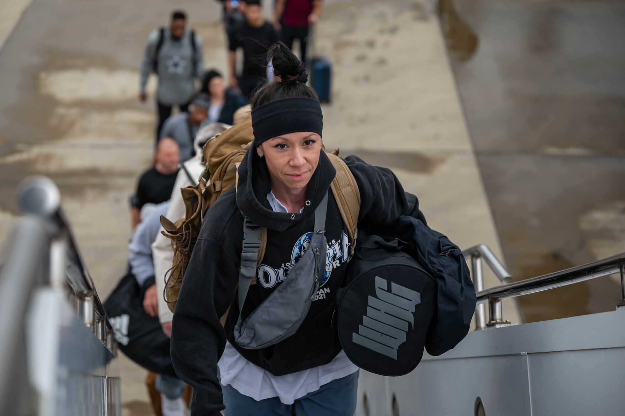 Photo of U.S. Air Force Airmen boarding a commercial KDC-10 aircraft