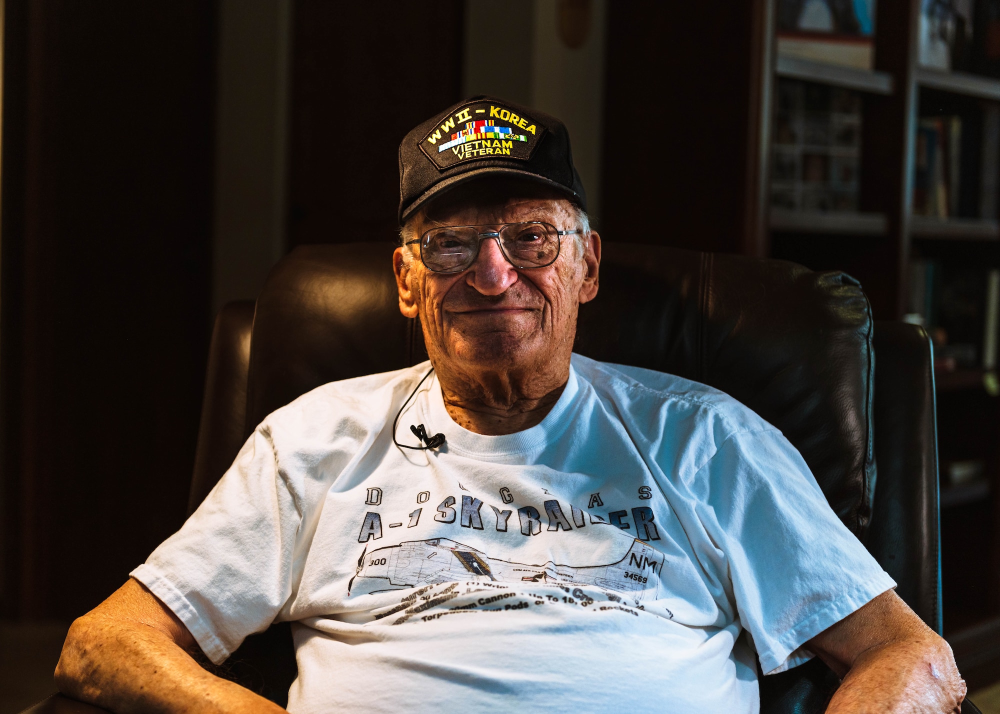 Retired U.S. Air Force Lt. Col. Richard Earl Michaud poses for a photo in his living room.