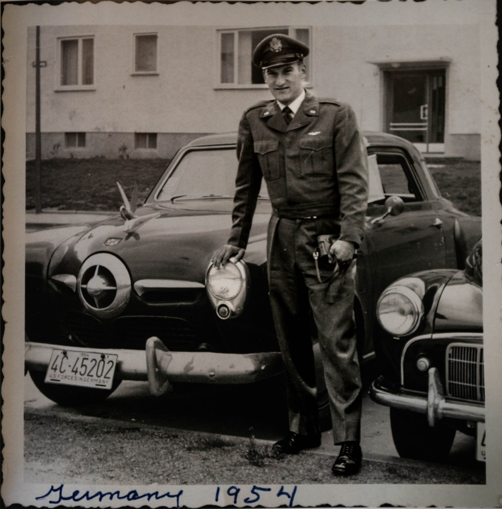 Retired U.S. Air Force Lt. Col. Richard Earl Michaud, retired pilot, and squadron commander, poses for a photo in front of a Studebaker.
