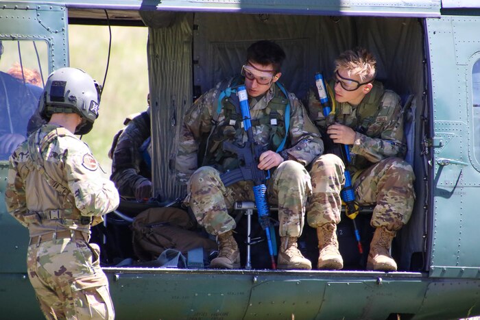 cadets sitting in a UH-1