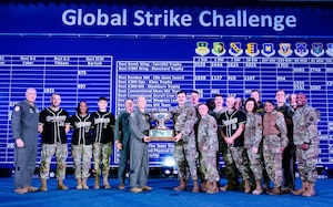 Airmen from the 28th Bomb Wing at Ellsworth Air Force Base, S.D., pose for a photo with the Chief Master Sergeant of the Air Force JoAnne Bass, the Air Force Global Strike Command commander, Gen. Thomas Bussiere and the AFGSC command chief, Chief Master Sgt. Melvina Smith after the 28th BW was awarded the Fairchild trophy at the Global Strike Challenge scoring ceremony on November 8, 2023 at Barksdale Air Force Base, La. The Fairchild trophy was awarded to the 28th BW for earning the highest combined score in operations, security forces and maintenance. (U.S. Air Force photo by Senior Airman William Pugh)