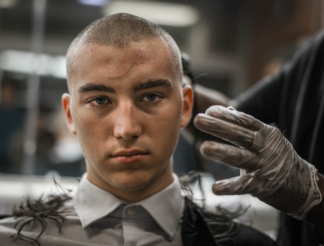 Gavin Kulczewski, a native of Aiken, South Carolina, receives a haircut as part of the accessioning process at Marine Corps Recruit Depot Parris Island, S.C., Nov. 7, 2023. Recruits begin the receiving process with administrative processing, gear issue, and haircuts. (U.S. Marine Corps photo by Lance Cpl. Ava Alegria)