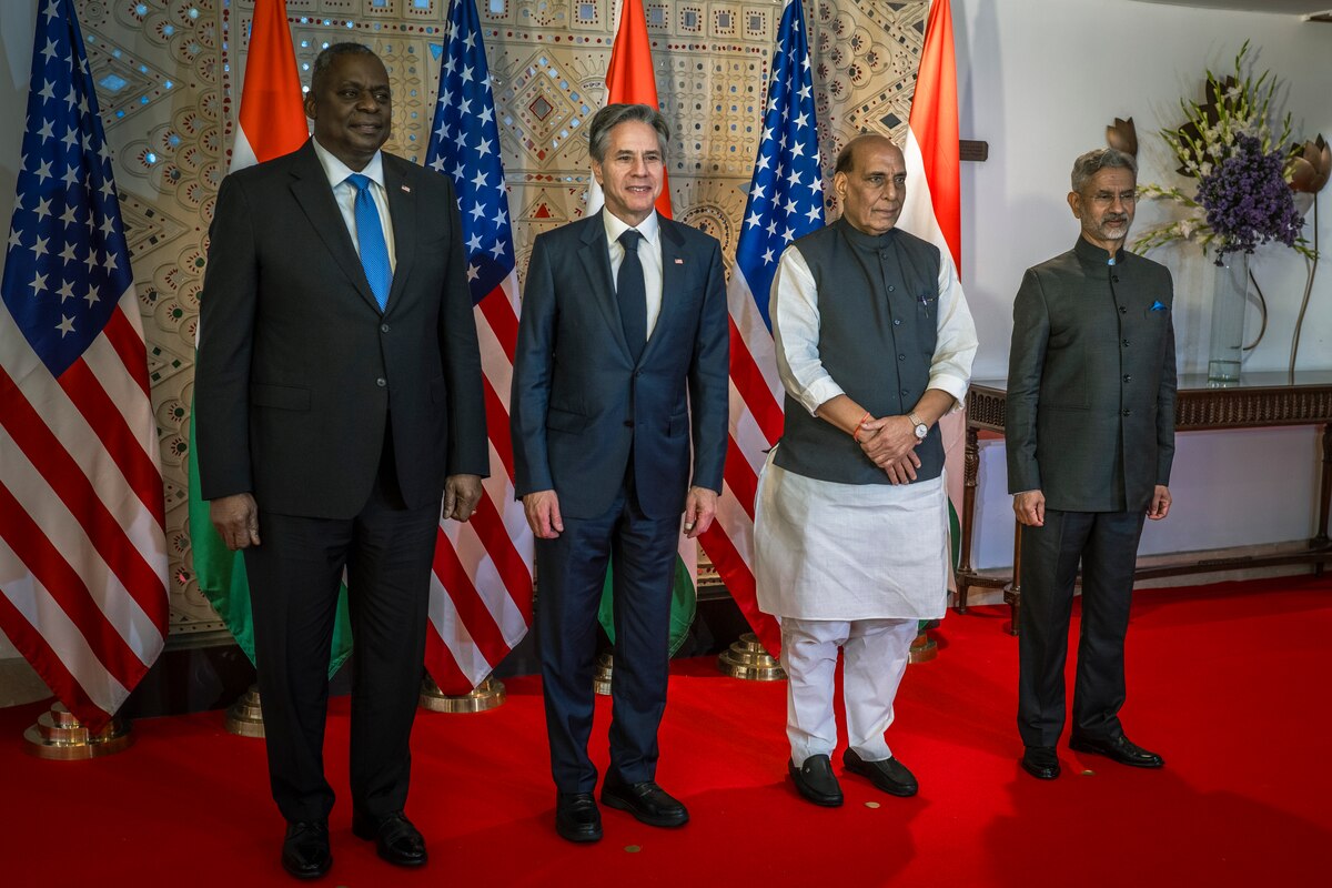 Four men stand next to each other and pose for a photo.