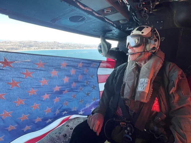 Retired U.S. Marine Corps and Army veteran Maj. Billy Hall gazes upon the California coastline during an honor flight in a UH-1Y Venom with Marine Light Attack Helicopter Squadron (HMLA) 267, Marine Aircraft Group 39, 3rd Marine Aircraft Wing, California, Nov. 11, 2023. Hall celebrated the 82nd anniversary of his Marine Corps Recruit Training graduation by flying with the Marines of HMLA-267. (U.S. Marine Corps photo by Sgt. Sean Potter)