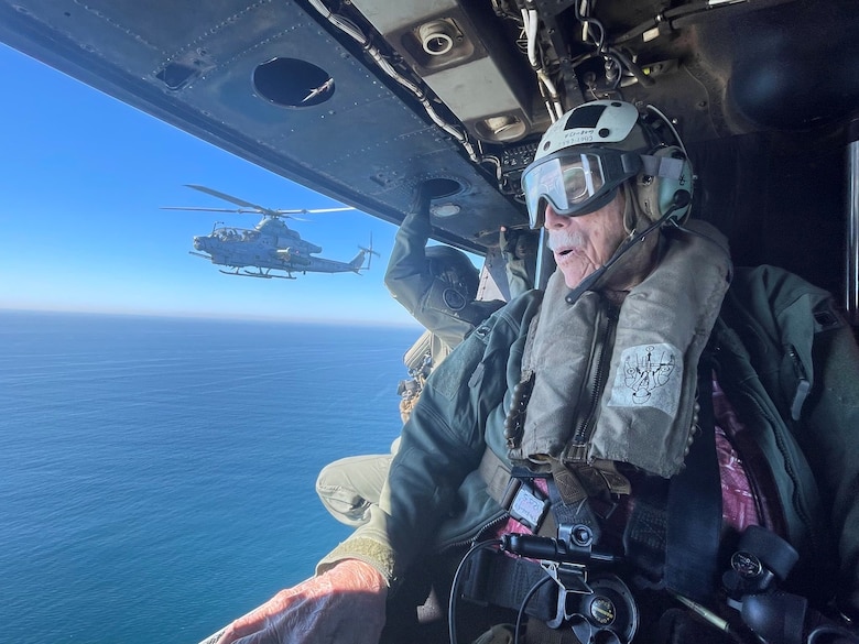 Retired U.S. Marine Corps and Army veteran Maj. Billy Hall gazes upon the California coastline during an honor flight in a UH-1Y Venom with Marine Light Attack Helicopter Squadron (HMLA) 267, Marine Aircraft Group 39, 3rd Marine Aircraft Wing, California, Nov. 11, 2023. Hall celebrated the 82nd anniversary of his Marine Corps Recruit Training graduation by flying with the Marines of HMLA-267. (U.S. Marine Corps photo by Sgt. Sean Potter)