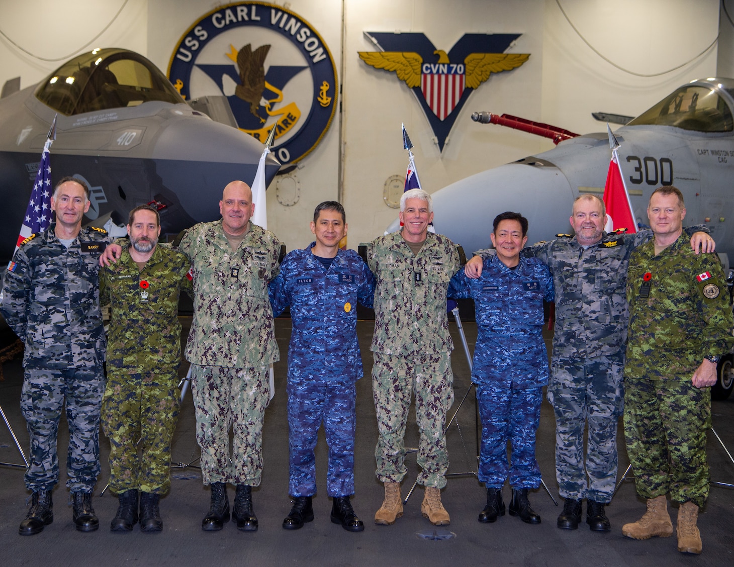231111-N-GR586-1421 PHILIPPINE SEA (Nov. 11, 2023) Senior leaders from Canada, Australia, Japan and U.S. pose for a photo aboard Nimitz-class aircraft carrier USS Carl Vinson (CVN 70) following a multinational press conference as part of Annual Exercise (ANNUALEX) 2023. ANNUALEX is a multilateral exercise conducted by naval elements of the Royal Australian, Royal Canadian, Japan Maritime Self-Defense Force, and U.S. navies to demonstrate naval interoperability and a joint commitment to a free and open Indo-Pacific. Vinson, flagship of Carrier Strike Group (CSG) ONE, is deployed to the U.S. 7th Fleet area of operations in support of a free and open Indo-Pacific. (U.S. Navy photo by Mass Communication Specialist 2nd Class Benjamin Ringers)