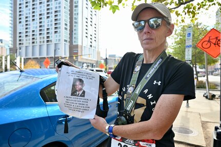 Jennifer Hickey completes her 240th marathon in Arlington, Va., during the Marine Corps Marathon, Oct. 29, 2023. Hickey ran in honor of Spc. Darryl T. Dent, a District of Columbia National Guard member assigned to the 547th Transportation Company. The 21-year-old died Aug. 26, 2003, when an improvised explosive device struck his vehicle in Southeast Arimaji, Iraq. (U.S. Air Force photo by Master Sgt. Arthur Wright)