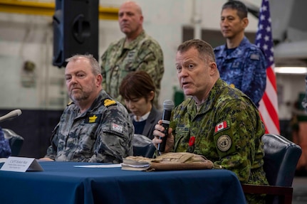 231111-N-TL932-1179 PHILIPPINE SEA (Nov. 11, 2023) Capt. Robert Watt, right, Canadian Defense Attaché to Japan, Royal Canadian Navy, and Commadore Michael Harris, Director General Maritime Operations, Royal Australian Navy, conduct a multilateral press conference aboard Nimitz-class aircraft carrier USS Carl Vinson (CVN 70) as part of Annual Exercise (ANNUALEX) 2023. ANNUALEX is a multilateral exercise conducted by naval elements of the Royal Australian, Royal Canadian, Japan Maritime Self-Defense Force, and U.S. navies to demonstrate naval interoperability and a joint commitment to a free and open Indo-Pacific. Vinson, flagship of Carrier Strike Group ONE, is deployed to the U.S. 7th Fleet area of operations in support of a free and open Indo-Pacific. (U.S. Navy photo by Mass Communication Specialist 3rd Class Joshua Sapien)