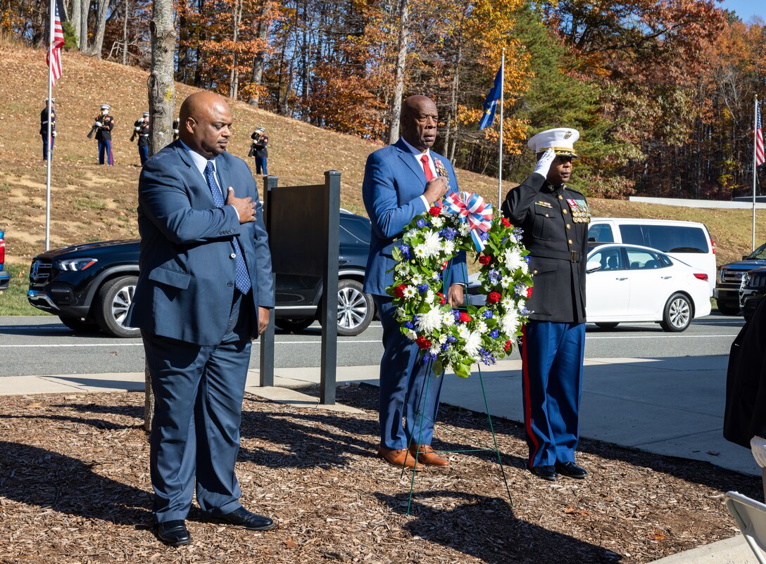 From left, James P. Sanders, director, National Memorial Cemetery at Quantico; U.S. Navy Rear Adm. Clyde Marsh, retired, and U.S. Marine Corps Col. Michael L. Brooks, commander, Marine Corps Base Quantico, render honors after placing a wreath during a Veteran’s Day ceremony at the National Memorial Cemetery at Quantico, Triangle, Virginia, Nov. 11, 2023. The ceremony was sponsored by the Potomac Region Veterans Council in partnership with Marine Corps Base Quantico and the Veterans Administration to honor all who have served. (U.S. Marine Corps Photo by Lance Cpl. Kayla LeClaire)